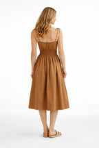 Woman wearing a brown dress on a white background