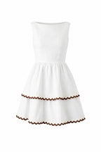 Stylish Bianca Mini Dress in white linen with scallop detailing and a tiered skirt, perfect for warm weather.